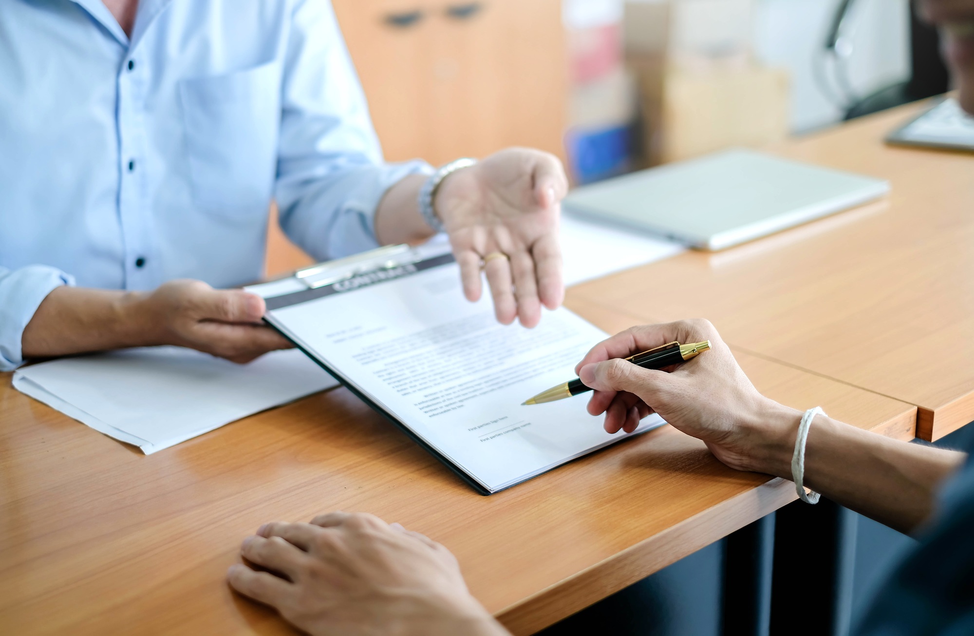 Man signing a contract. Signing an agreement in a document